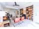 Inviting office with built-in bookshelves, mini-bar, modern furniture, and a sleek ceiling fan at 1100 Parker Ne Pl, Atlanta, GA 30324