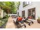 Spacious patio with lounge seating, an outdoor dining area, and serene garden views at 1100 Parker Ne Pl, Atlanta, GA 30324