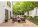 Serene patio with dining and lounge seating surrounded by beautiful landscaping, creating a private outdoor oasis at 1100 Parker Ne Pl, Atlanta, GA 30324