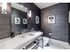 Stylish powder room with a modern sink, textured wallpaper, and elegant lighting fixtures at 1100 Parker Ne Pl, Atlanta, GA 30324