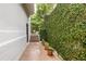 Scenic walkway with potted plants and lush ivy-covered wall leading to an outdoor seating area at 1100 Parker Ne Pl, Atlanta, GA 30324