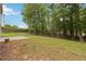 A spacious grassy yard leads to a wooded area in this home's backyard at 1931 Abinger Way, Lawrenceville, GA 30043