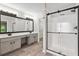 Bathroom featuring double sinks, a large mirror, and walk-in shower with glass doors at 1931 Abinger Way, Lawrenceville, GA 30043