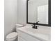 Bathroom featuring a single sink, toilet and dark fixtures at 1931 Abinger Way, Lawrenceville, GA 30043