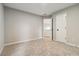 A spacious, empty bedroom with an entrance to an ensuite bathroom and light carpet at 1931 Abinger Way, Lawrenceville, GA 30043