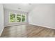 Primary bedroom with vaulted ceiling and a wall of windows overlooks the backyard at 1931 Abinger Way, Lawrenceville, GA 30043