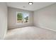 A light-filled empty bedroom with carpeted floors and a bright, large window at 1931 Abinger Way, Lawrenceville, GA 30043