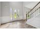 Bright foyer featuring new floors, wainscoting, and a staircase with wood trim at 1931 Abinger Way, Lawrenceville, GA 30043