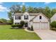 Charming two-story home with a manicured front yard and a two-car garage at 1931 Abinger Way, Lawrenceville, GA 30043