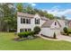 Well-maintained two-story home with lush landscaping and a two-car garage at 1931 Abinger Way, Lawrenceville, GA 30043