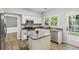 Beautiful kitchen features stainless appliances, a center island, and a view to the backyard at 1931 Abinger Way, Lawrenceville, GA 30043