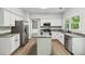 Charming kitchen with stainless steel appliances, granite countertops, and center island at 1931 Abinger Way, Lawrenceville, GA 30043
