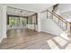 Bright living room area features hardwood floors, modern chandelier, and staircase at 1931 Abinger Way, Lawrenceville, GA 30043