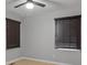 Bedroom featuring hardwood floors, ceiling fan, and window with dark wood blinds at 2917 Reveille Se Cir, Atlanta, GA 30316