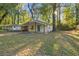 Street view of a well-kept single-story home with a covered porch and lush greenery surrounding the property at 2917 Reveille Se Cir, Atlanta, GA 30316