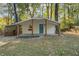 Charming single-story home with a covered front porch and bright blue front door surrounded by mature trees at 2917 Reveille Se Cir, Atlanta, GA 30316