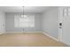 Bright living area featuring large windows, modern floors, and a contemporary chandelier at 2917 Reveille Se Cir, Atlanta, GA 30316