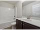 Bathroom featuring a tub with shower and a vanity with a mirror and cabinet at 3373 Shoals Ridge Dr, Dacula, GA 30019