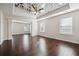 An open bedroom and living area are accented by hardwood floors and a stylish ceiling fan at 3373 Shoals Ridge Dr, Dacula, GA 30019