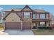 Charming two-story brick home boasts a two-car garage and a well-maintained front lawn at 3373 Shoals Ridge Dr, Dacula, GA 30019