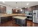 Modern kitchen with stainless steel appliances, granite countertops, and a central island at 3373 Shoals Ridge Dr, Dacula, GA 30019