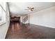 Open-concept living room featuring hardwood floors, neutral paint, and access to the kitchen and staircase at 3373 Shoals Ridge Dr, Dacula, GA 30019