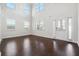 Sunlit living room featuring soaring ceilings, large windows, and hardwood floors with modern finishes at 3373 Shoals Ridge Dr, Dacula, GA 30019