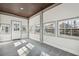 Bright sunroom with tile flooring, multiple windows and backyard views offers serene relaxation at 3373 Shoals Ridge Dr, Dacula, GA 30019