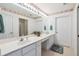 Bathroom with double sink vanity, large mirror, decorative wallpaper and enclosed shower and bath at 3746 Vineyards Lake Nw Cir # U6, Kennesaw, GA 30144