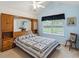 Bright bedroom features built-in headboard with storage, vaulted ceiling, and large window at 3746 Vineyards Lake Nw Cir # U6, Kennesaw, GA 30144