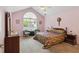 Bedroom with vaulted ceiling, large arched window, plush carpet and classic furnishings at 3746 Vineyards Lake Nw Cir # U6, Kennesaw, GA 30144