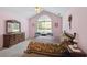 Bedroom with vaulted ceiling, large arched window, plush carpet and classic furnishings at 3746 Vineyards Lake Nw Cir # U6, Kennesaw, GA 30144