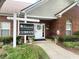 Charming clubhouse with a brick facade, a welcome sign, and manicured landscaping at 3746 Vineyards Lake Nw Cir # U6, Kennesaw, GA 30144