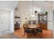Charming dining area featuring wood floors, traditional furnishings, and a view into the kitchen at 3746 Vineyards Lake Nw Cir # U6, Kennesaw, GA 30144