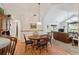 Bright dining area with wood floors, a round table, and views into living room at 3746 Vineyards Lake Nw Cir # U6, Kennesaw, GA 30144