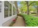 Exterior shot of home with well-manicured bushes along a sidewalk lined street and neighborhood in the background at 3746 Vineyards Lake Nw Cir # U6, Kennesaw, GA 30144