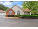 Charming home featuring a mix of beige siding, brick, large windows, and well-maintained landscaping at 3746 Vineyards Lake Nw Cir # U6, Kennesaw, GA 30144