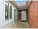 Welcoming front entry with a brick wall, glass-paned doors, and a covered porch area at 3746 Vineyards Lake Nw Cir # U6, Kennesaw, GA 30144