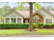 Charming home featuring large windows, brick accents, manicured hedges, and a well-maintained lawn at 3746 Vineyards Lake Nw Cir # U6, Kennesaw, GA 30144