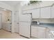 Well-maintained kitchen area with modern appliances, a laundry area, and lots of storage at 3746 Vineyards Lake Nw Cir # U6, Kennesaw, GA 30144