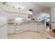 Efficient kitchen featuring white appliances, ample counter space, and open access to the living room at 3746 Vineyards Lake Nw Cir # U6, Kennesaw, GA 30144
