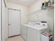 Bright laundry room features a washer, dryer and wire shelving for ample storage space at 3746 Vineyards Lake Nw Cir # U6, Kennesaw, GA 30144
