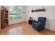 Living room with hardwood floors, large window, and a comfortable blue recliner at 3746 Vineyards Lake Nw Cir # U6, Kennesaw, GA 30144