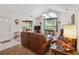Warm living room features high ceilings, a fireplace, neutral tones, and a view to an adjacent room at 3746 Vineyards Lake Nw Cir # U6, Kennesaw, GA 30144