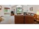 Cozy living room features vaulted ceiling, carpet, and a view to a sunroom and a white fireplace at 3746 Vineyards Lake Nw Cir # U6, Kennesaw, GA 30144