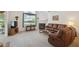 Cozy living room with plush carpet, fireplace, neutral walls, and comfortable leather seating at 3746 Vineyards Lake Nw Cir # U6, Kennesaw, GA 30144