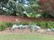 Entrance signage for 'The Vineyards' community with flowers and beautiful landscaping at 3746 Vineyards Lake Nw Cir # U6, Kennesaw, GA 30144