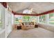 Bright sunroom featuring multiple windows, neutral decor, and comfortable wicker furniture at 3746 Vineyards Lake Nw Cir # U6, Kennesaw, GA 30144