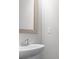 Close up view of single sink bathroom with chrome fixtures and light wood mirror at 7168 Kingswood Run Dr, Atlanta, GA 30340