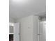 This bedroom has neutral walls and trim with a bathroom nearby at 7168 Kingswood Run Dr, Atlanta, GA 30340